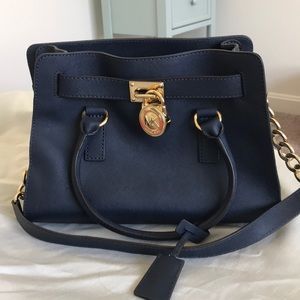 Michael Kors navy handbag with gold metal accents